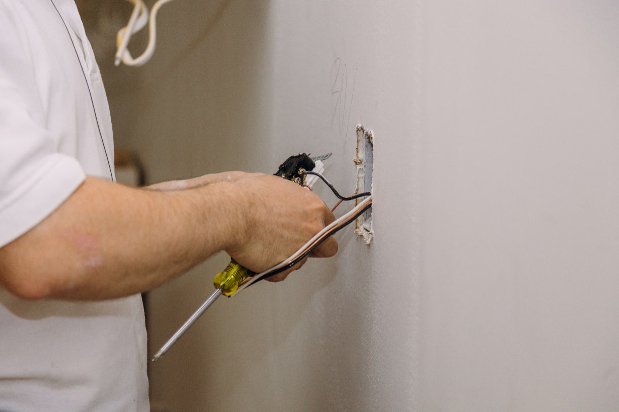 Hands professional on installing electrical outlets Hands professional on installing electrical outlets